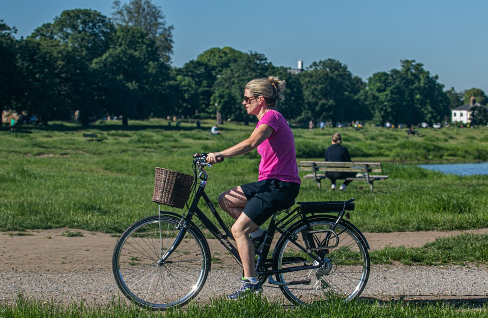 A cyclist heads out for a ride on Wimbledon Common this morning