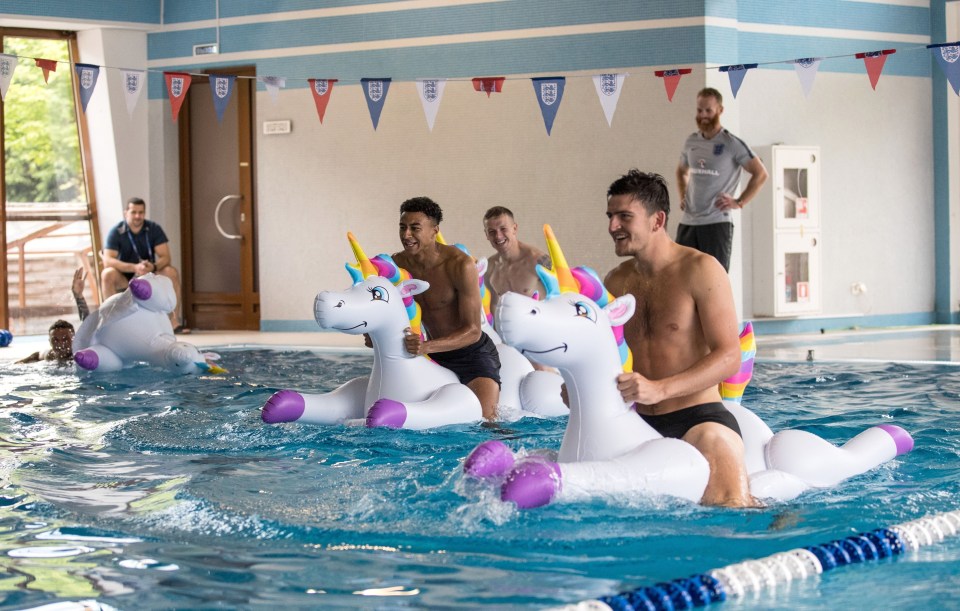 Kieran Trippier, Jordan Pickford, Jesse Lingard and Harry Maguire play with inflatable unicorns in the pool during a recovery session in 2018