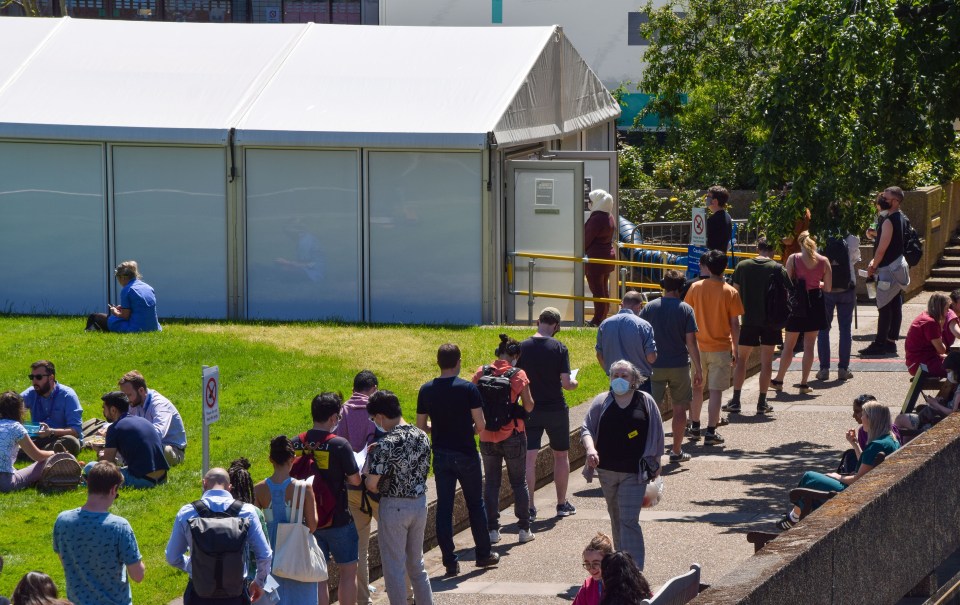 People queue up outside the Covid-19 vaccination centre at St Thomas' Hospital in London