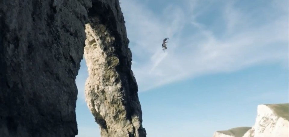 The video shows him jumping off Durdle Door