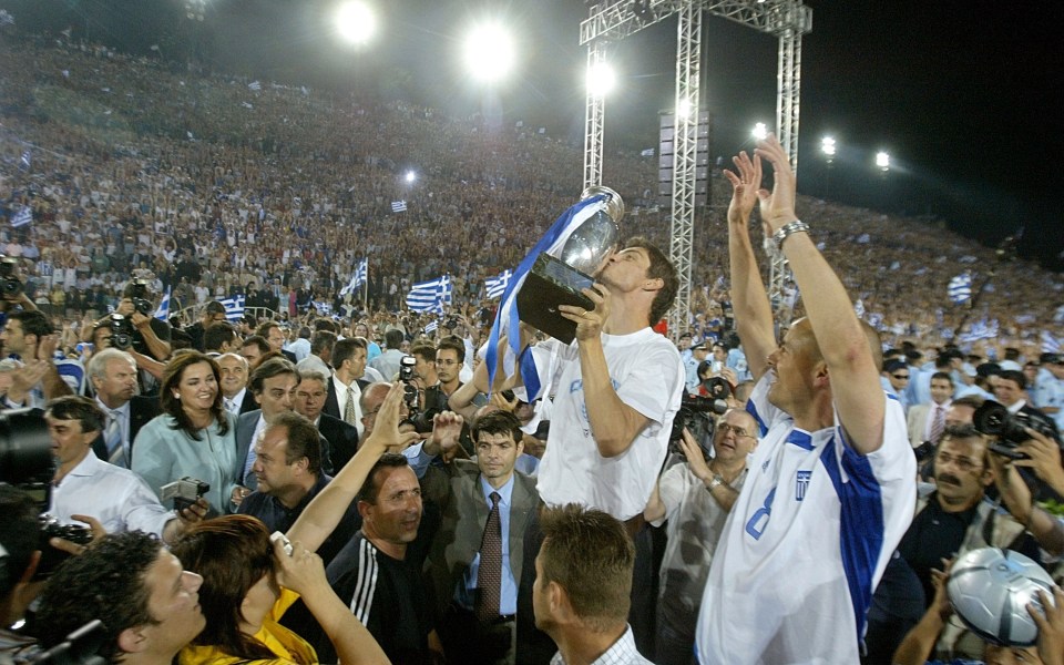 Greece striker Angelos Charisteas celebrates back in Athens with the fans after the tournament