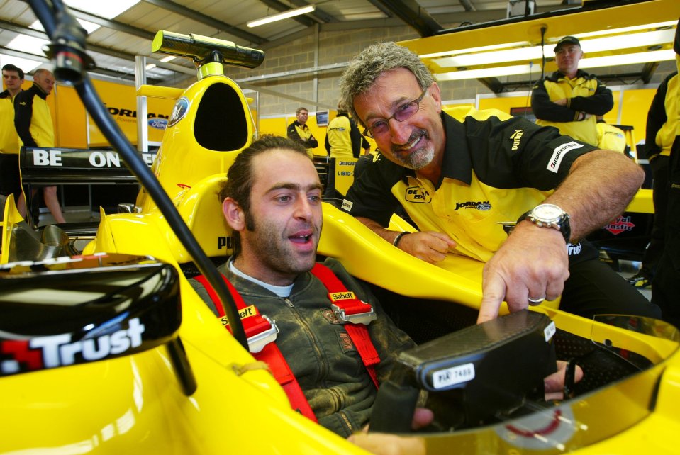 Ronnie displays his love for fast cars - as he sits in an F1 racer with former team boss Eddie Jordan