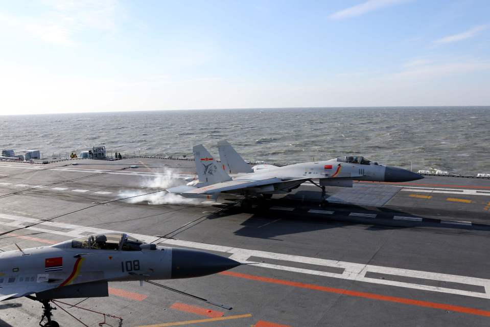 A Chinese J-15 fighter jet landing on the deck of the Liaoning aircraft carrier