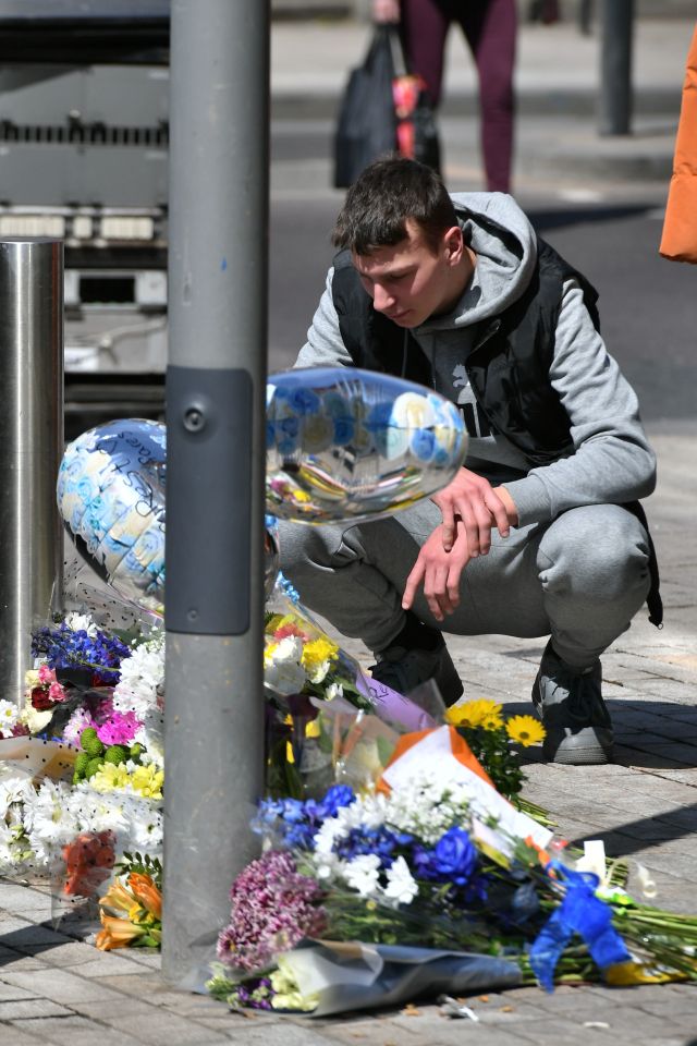 Mourners place flowers at the scene where 14-year-old Fares Maatou was knifed to death