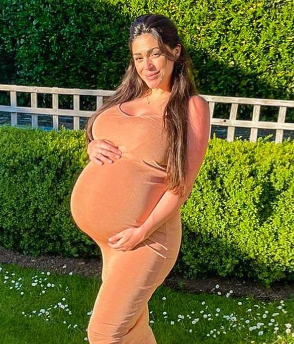 Casey Batchelor has revealed her blossoming baby bump as she prepares to give birth 'any day now'