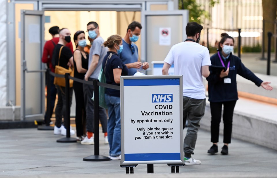 People enter a Covid vaccination centre in London