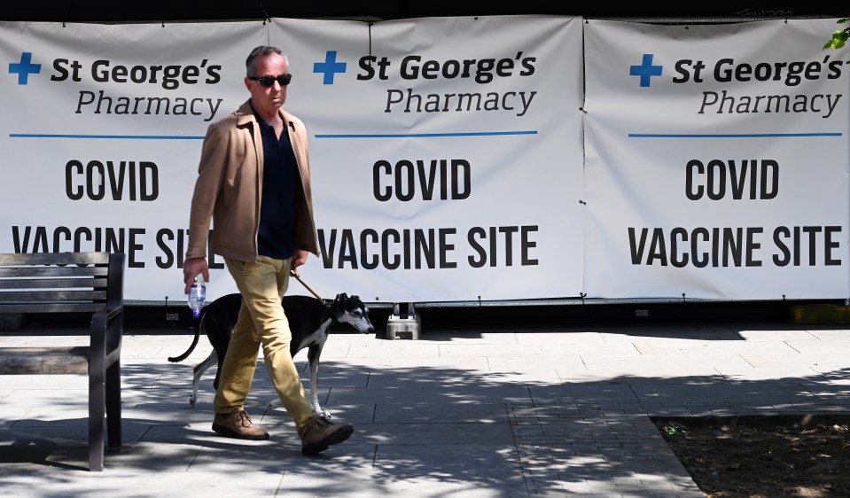 A member of the public passes a vaccination centre in London