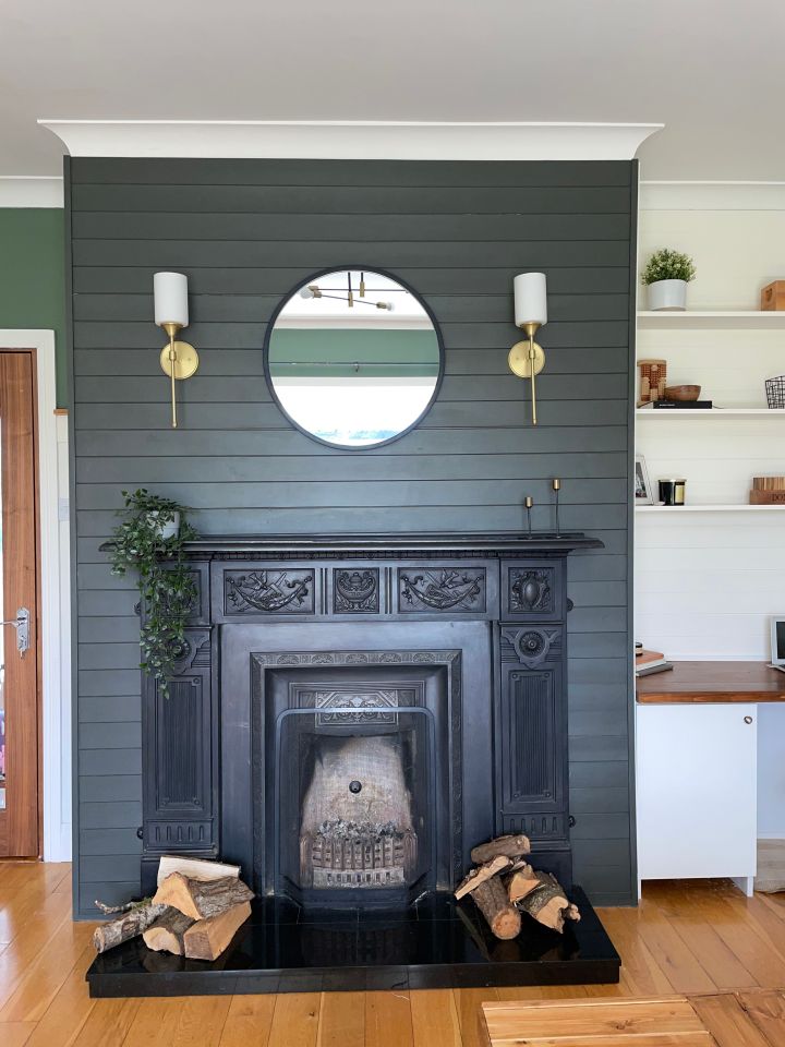 She also created custom shelving seen here next to the fireplace, and breathed new life into her home using paint