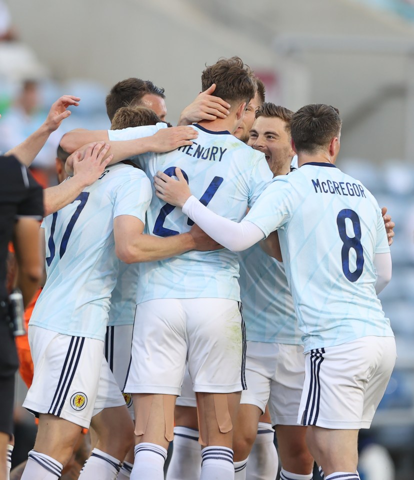 Celtic hitman Jack Hendry is mobbed by his team-mates after firing Scotland into the lead