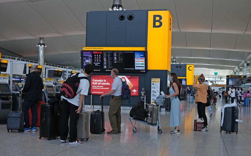 Passengers check in at Heathrow Airport Terminal 2 Departures