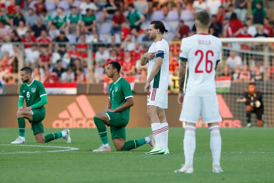 Hungary point to the Uefa Respect badge as Ireland take the knee