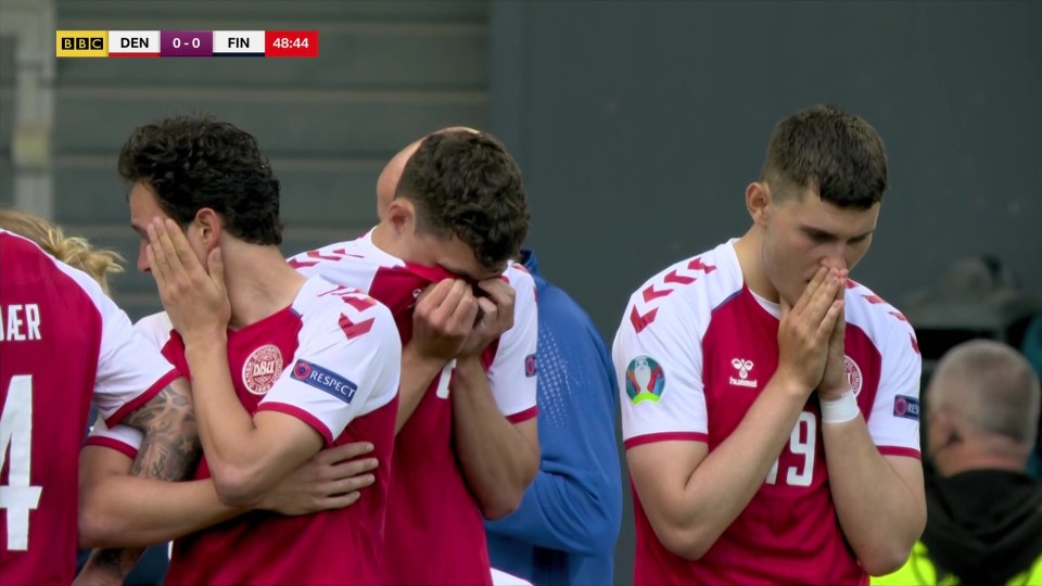 Shocked Danish players held their head in their hands as medics attended to their team-mate