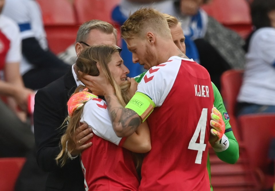  Sabrina consoled by Eriksen's team-mate Simon Kjaer