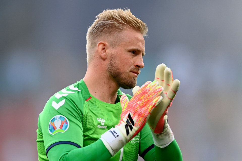 Denmark’s goalkeeper Kasper Schmeichel applauds as he returns to the pitch to resume the match