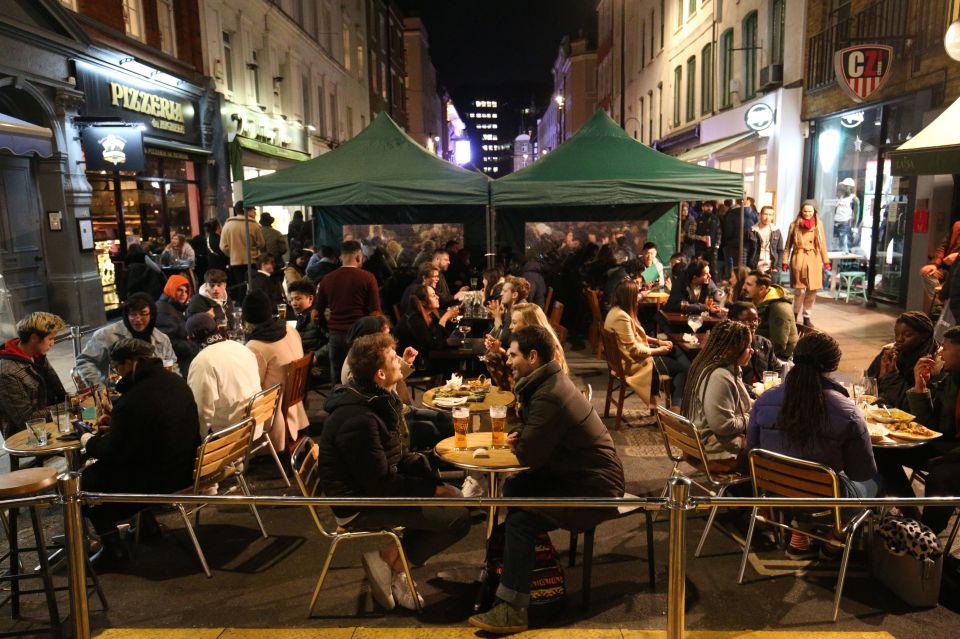 Diners outside Laxsa Soho on Old Compton Street, London