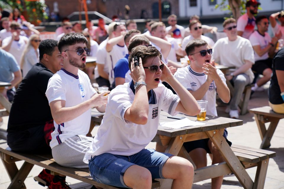 A man holds his head in his hands as Phil Foden hits the post