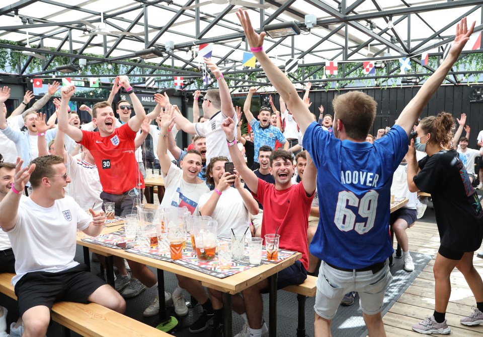 A fan cheers with his mates after Sterling scored