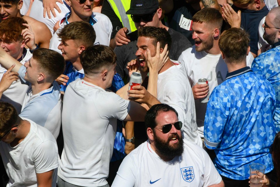 Two fans embrace after England score