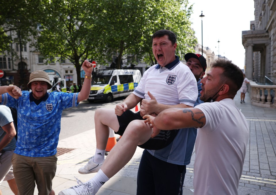 A fan gets a lift from his mates after England snatched a win