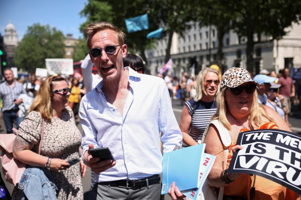 Protesters were seen holding placards as they marched in front of Downing Street