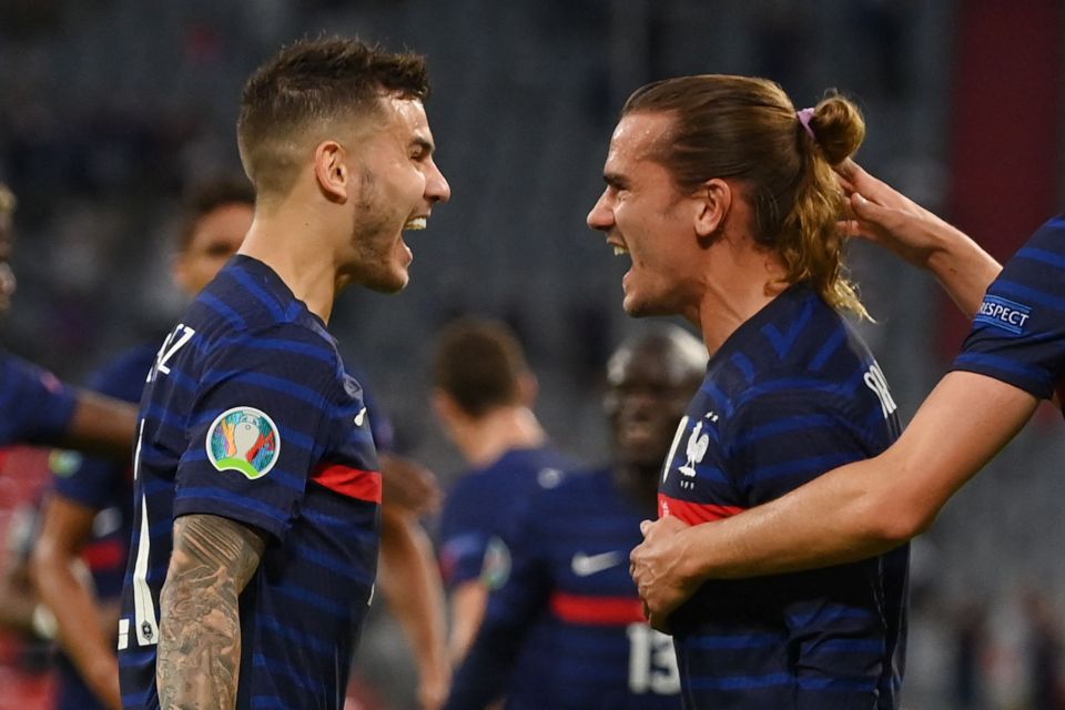 Defender Lucas Hernandez celebrates with France team-mate Antoine Griezmann after the own goal opener from Germany's Mats Hummels