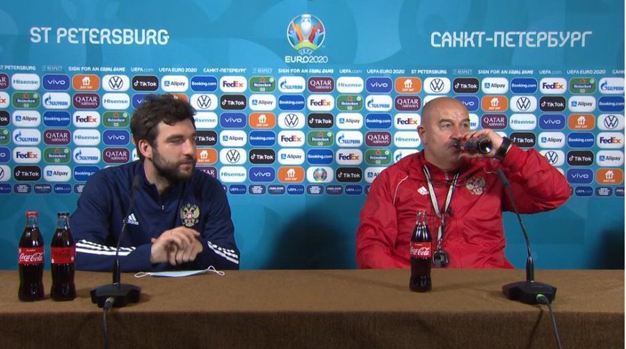 Russia boss Stanislav Cherchesov (right) toasted the win over Finland with a bottle of Coke