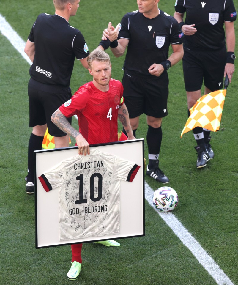 Denmark captain Simon Kjaer was presented with a framed shirt by the Belgium team