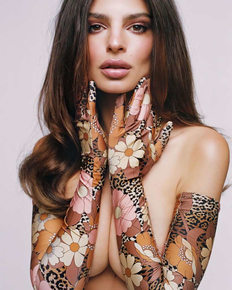 Emily Ratajkowski poses topless in flower-patterned gloves from her new swimwear collection