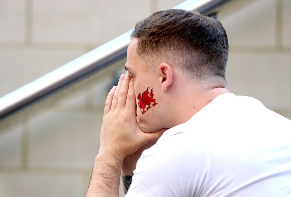 A Wales fan in Cardiff city centre reacts after his team was knocked out