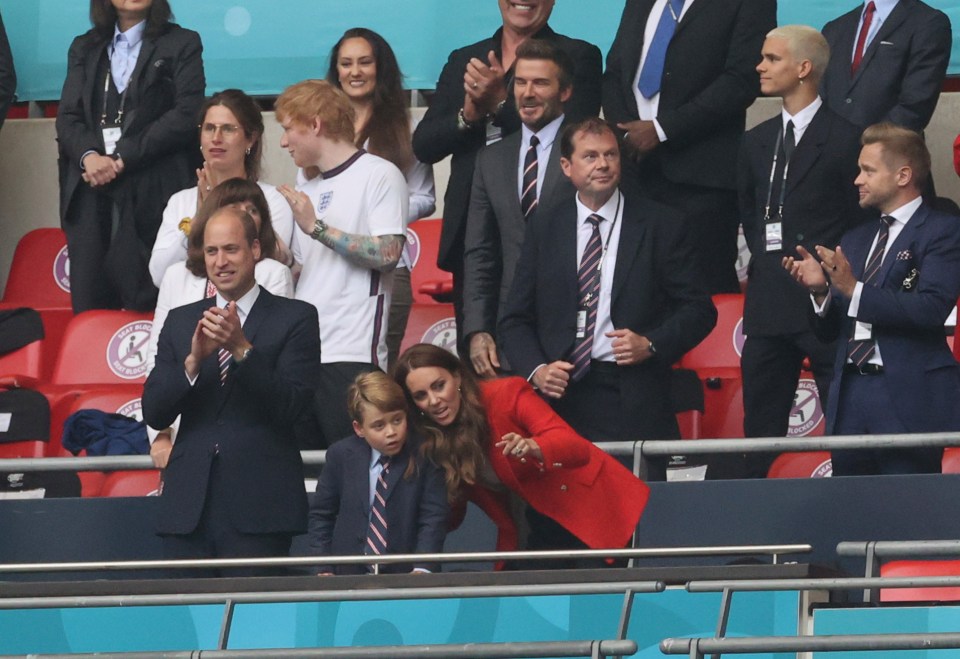 Kate Middleton points to some of the action on the pitch