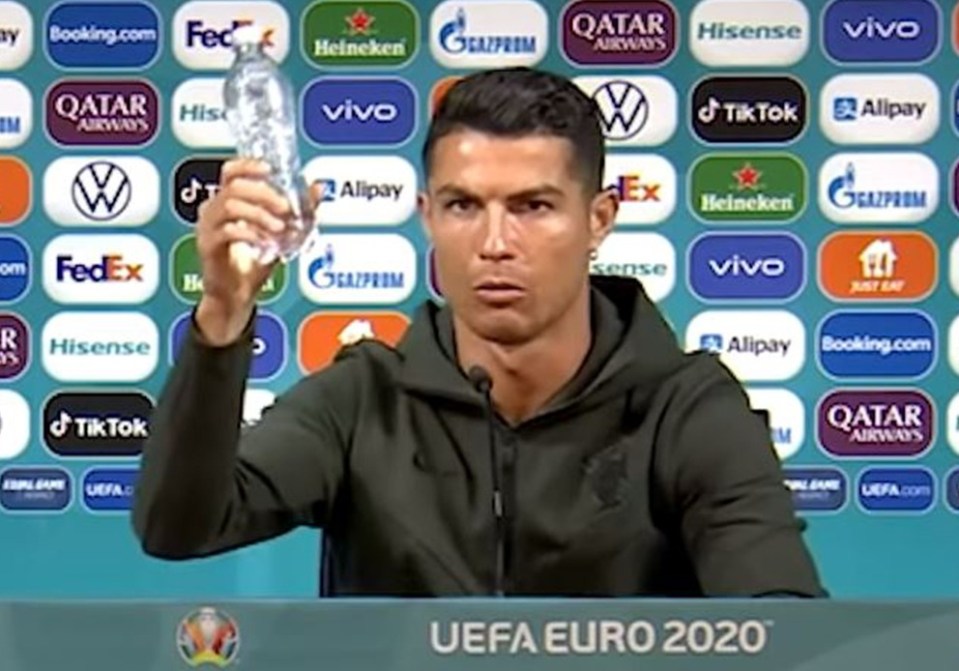 The Portugal international told fans 'agua', meaning 'water', as he pushed Coca-Cola bottles out of sight of the cameras