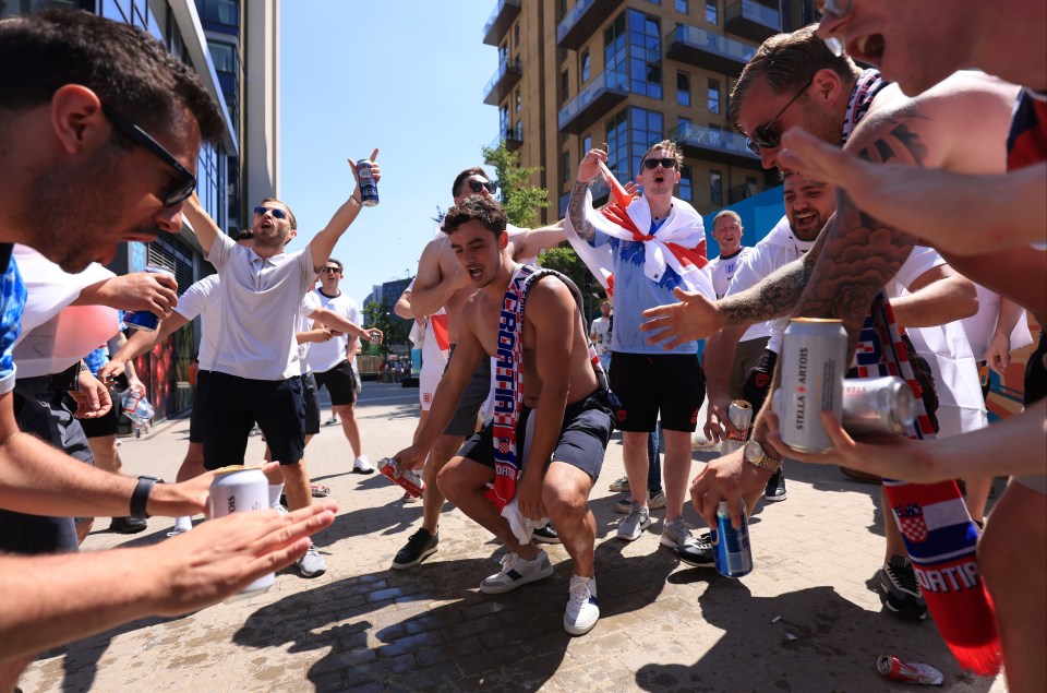 A topless fan dances in Wembley cheered on by his mates