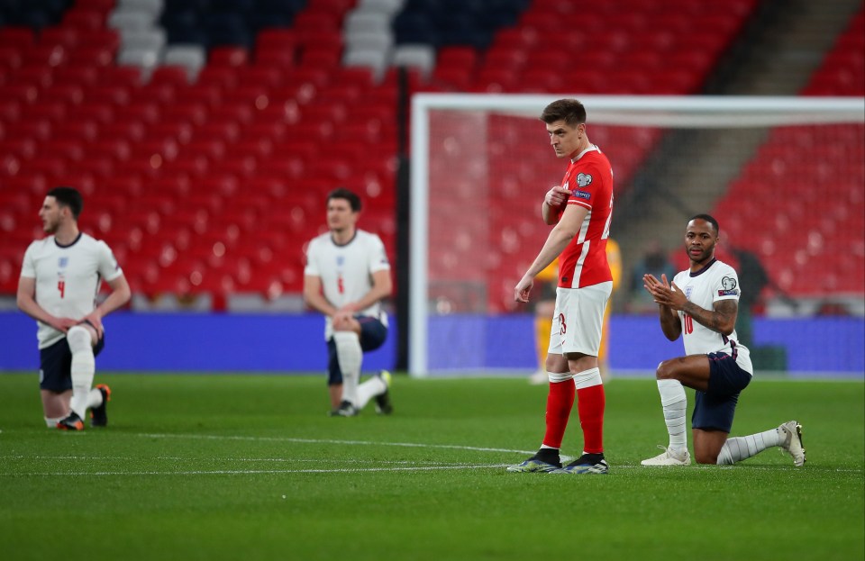 Poland point to their Uefa Respect badge as England take the knee