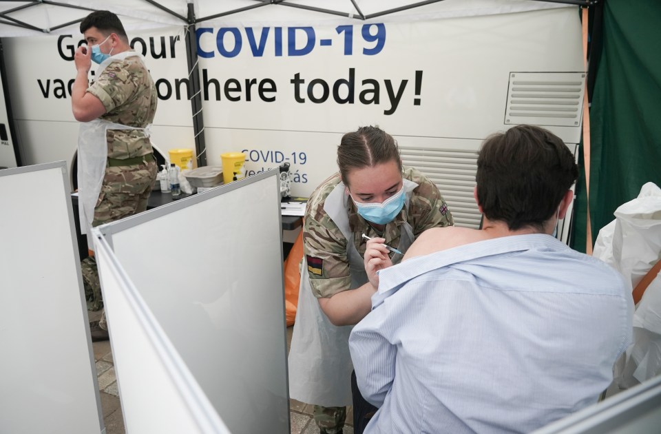 Combat medics vaccinate members of the public at a centre outside Bolton Town Hall