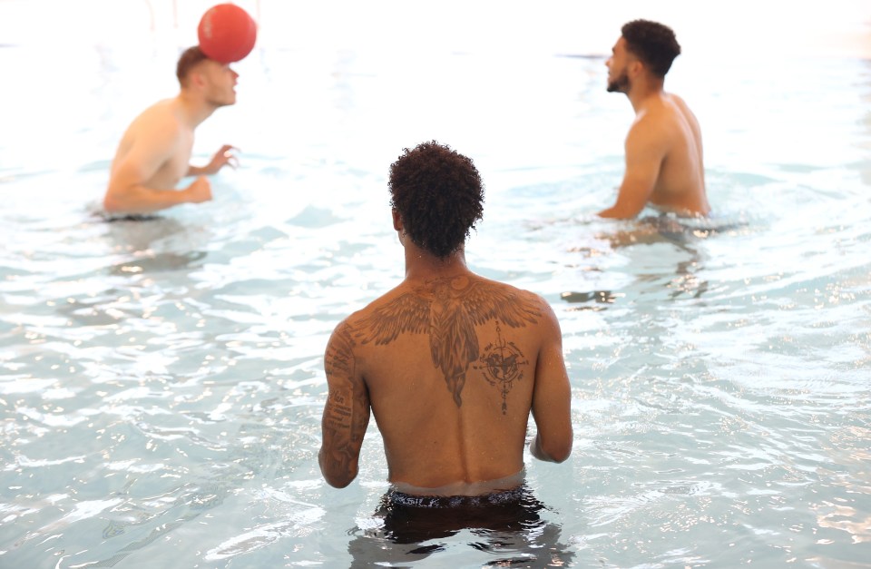 Marcus Rashford of England looks on in the swimming pool