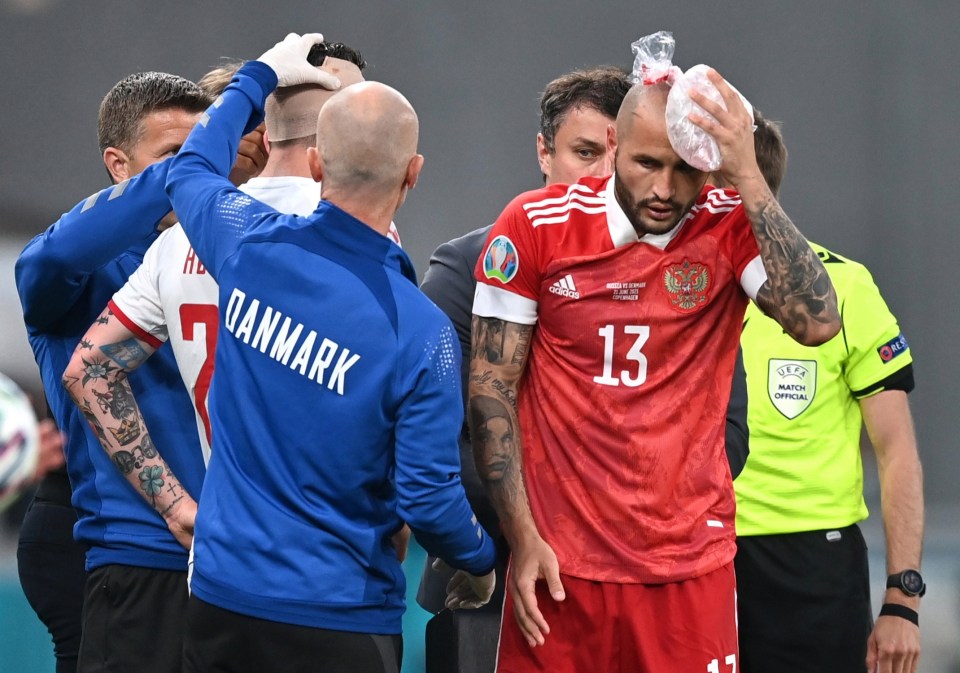 Russia's Fyodor Kudryashov receives treatment after his collision with Pierre-Emile Hojbjerg