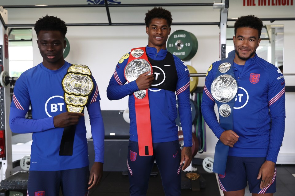 (Left to right) Bukayo Saka, Marcus Rashford and Reece James pose with the AEW belts