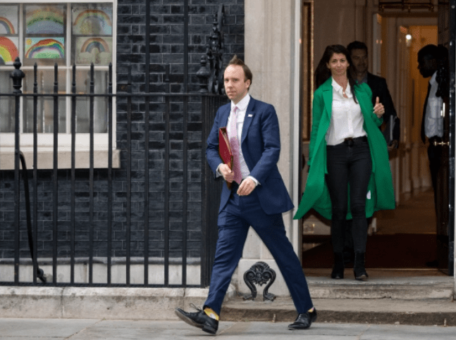 Mr Hancock leaves Downing Street with Ms Coladangelo behind him