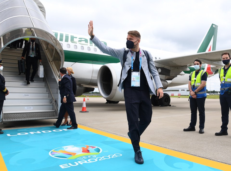 Ciro Immobile  waves for the cameras as he steps foot onto the tarmac in England