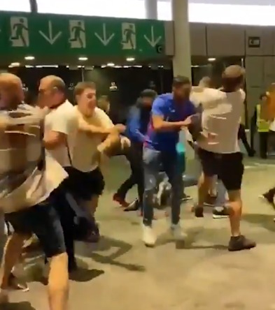 A clip posted to Twitter appears to show violence erupt at the door into the stands