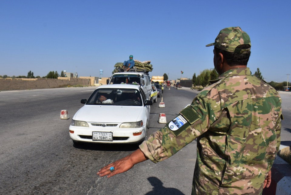 An Afghan soldier stands guard at a security checkpoint in Mazar-i-Sharif in Balkh province