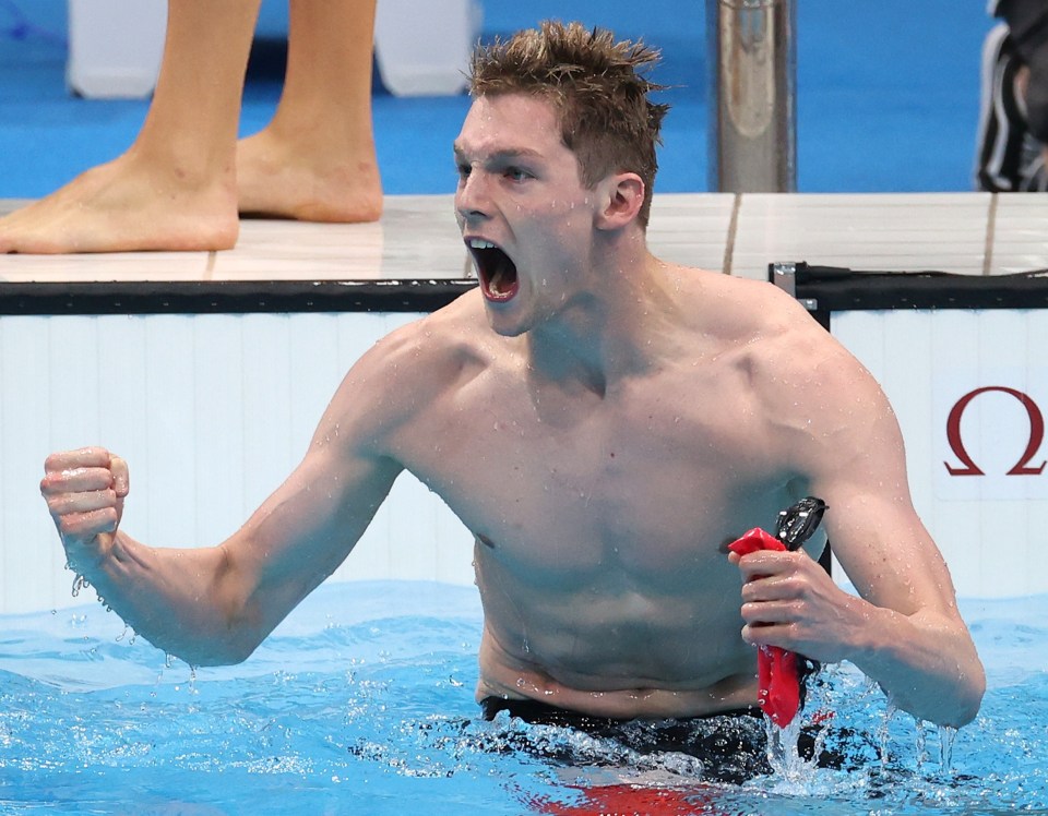 Duncan Scott celebrates after bringing Britain home in the relay