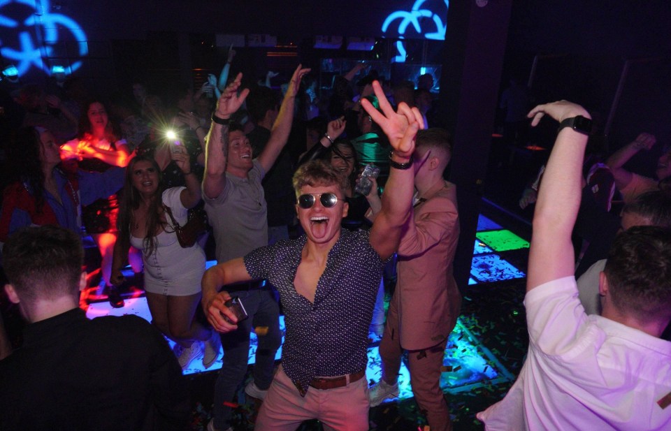 One reveller beams as he dances on the dance floor