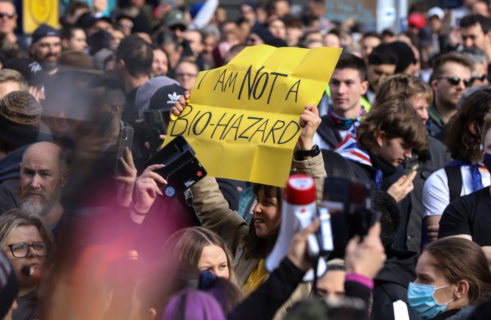 A protester writes 'I am not a bio-hazard'