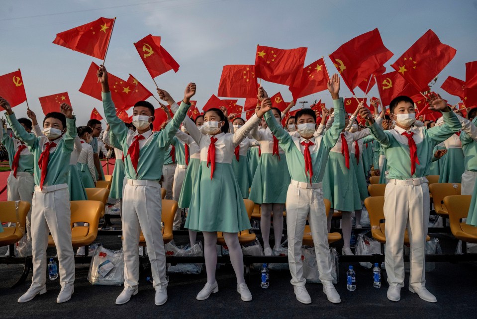 The distinctive red hammer and sickle flags are waved for the Communist Party