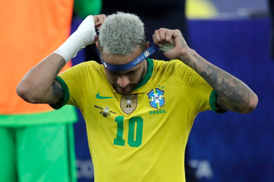 Neymar takes off his runners-up medal after the defeat