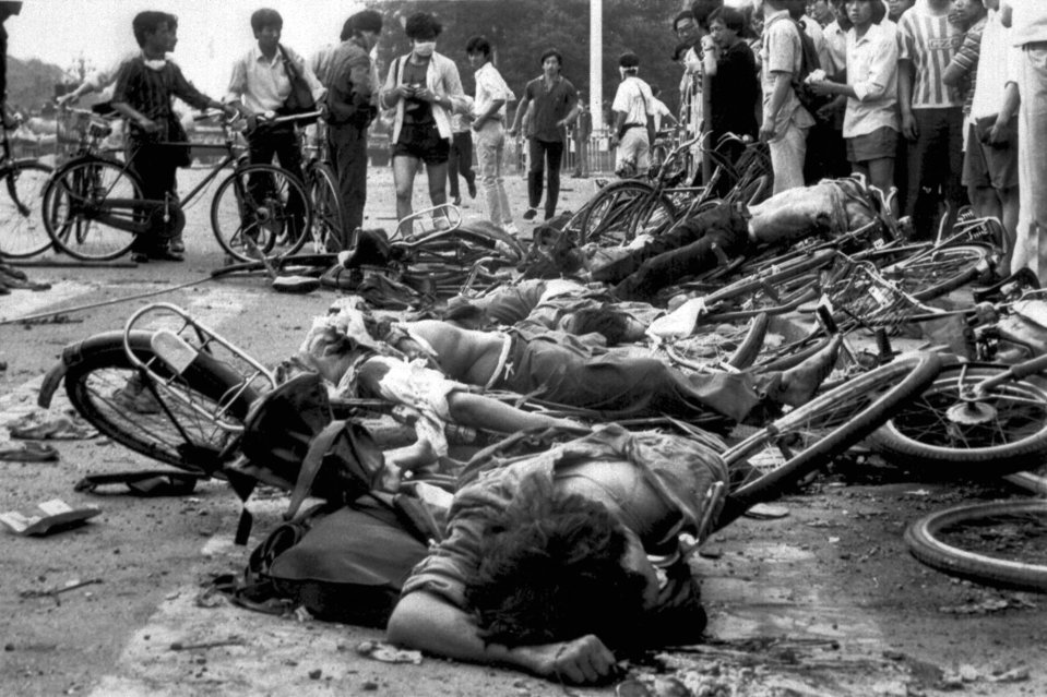 The bodies of civilians lie among mangled bicycles near Beijing's Tiananmen Square