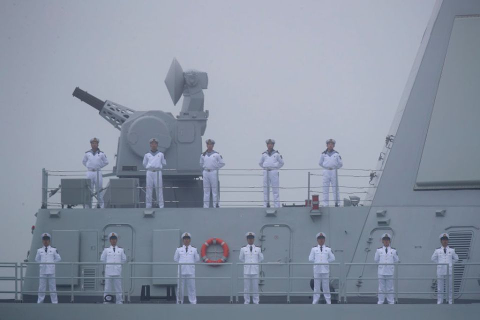 Sailors stand on the deck of China's new Type 055 guide missile destroyer