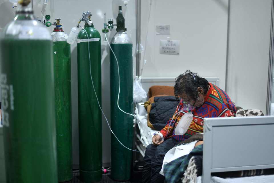 A patient sits on the bed at the Covid-19 ward at the Honorio Delgado Hospital in Arequipa, Peru