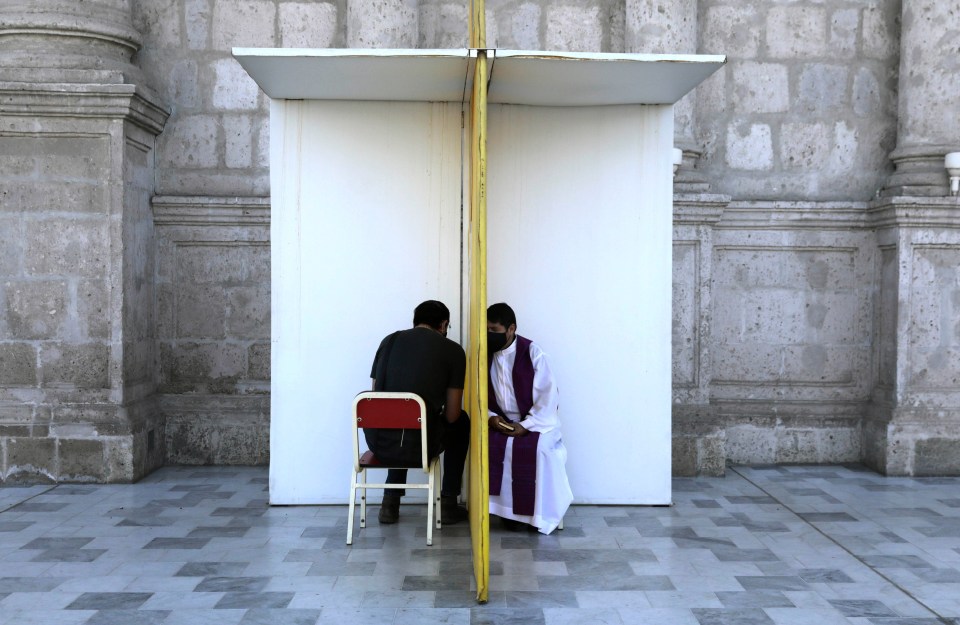 A priest listens to a parishioner's confession outside the Cathedral in Arequipa